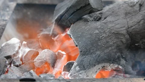 Beautiful red fire from dark grey black coals inside metal brazier.  Stock-Footage 130372557