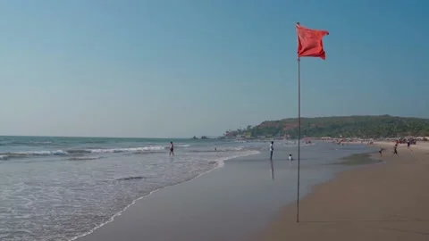 Beautiful red flag blowing in the wind, the beaches of India Video stock 225310188