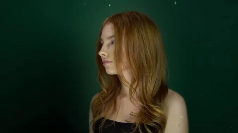 Beautiful red-haired girl posing on green background. Stock Footage 84691815