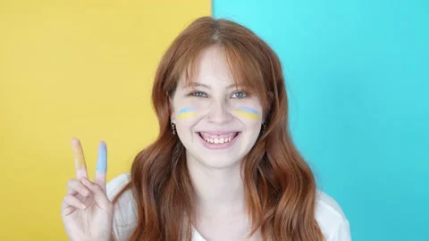 A beautiful red-haired Ukrainian makes the symbol of love and peace Stock Footage 171479787