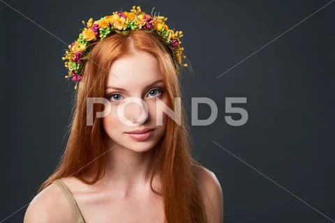 Beautiful red haired woman in flower wreath Stock Photos
