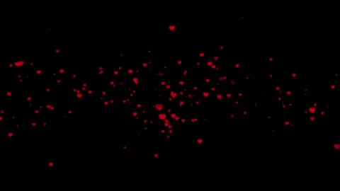 Beautiful red heart particles floating and twinkling on a dark background loo Stock Footage 319514583