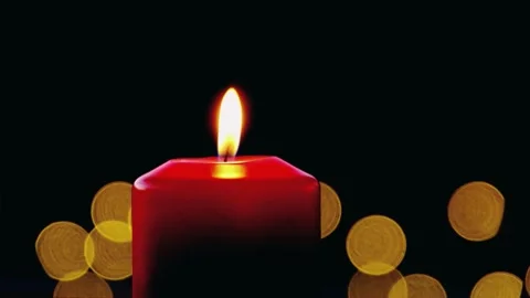 Beautiful red ignitting candle light with bokeh lights black background Stock Footage 247355481