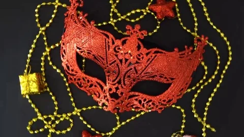 Beautiful red mask with small decorations rotating on a black background Stock Footage 69149480