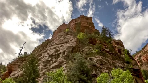 Beautiful red sandstone cliffs with a dramatic cloudscape - time lapse Stock Footage 108709127