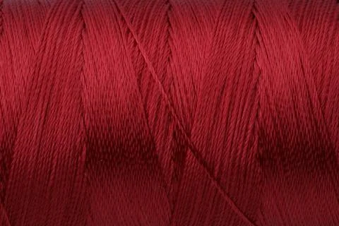 Beautiful red sewing thread as background, closeup Foto stock