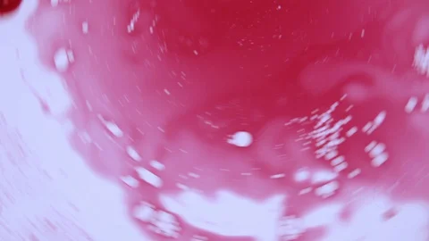Beautiful red splash spinnin with bubbles Stock Footage 127723176