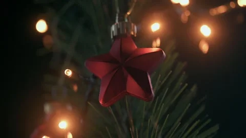 Beautiful red star on a blinking Christmas tree ​ Stock Footage 258357686