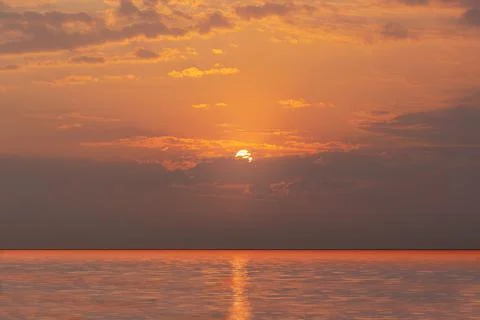 Beautiful red sunset, dark clouds and atlantic ocean on the horizon Stock Photos