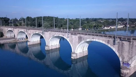 Beautiful reflection in the blue water from the train bridge over Mincio river Stock Footage 126901806