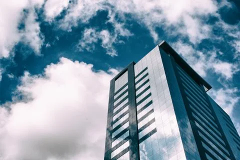 Beautiful reflection of the clouds in glass windows of an office building Stock-Fotos