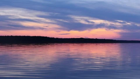 A beautiful reflection in the lake water of the sunset sky. Stock Footage 155686244
