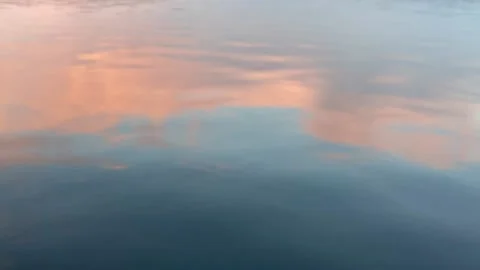 Beautiful reflection of pink clouds at sunset in the water of a forest lake Stock Footage 220913223