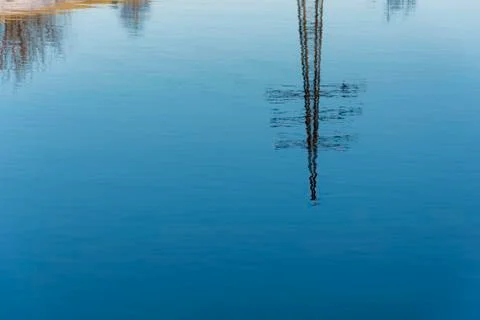 A beautiful reflection of the power line in the mirror smooth surface of the Stock Photos