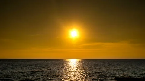 Beautiful reflection of rays of setting Sun on the ocean Stock Footage 157553340