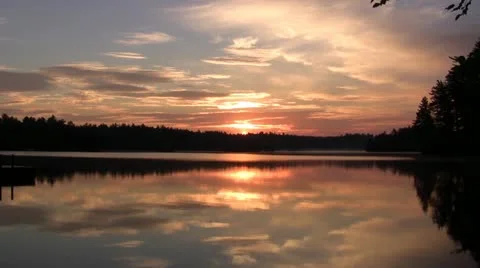Beautiful Reflection of Sun Rising over Lake Stock Footage 11242260