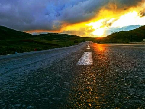 Beautiful reflection of sunset on the asphalt Stock Photos