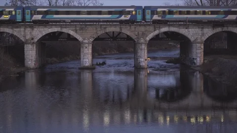 Beautiful reflection of the train passing the bridge. Bridge, train and river. Stock Footage 127354622