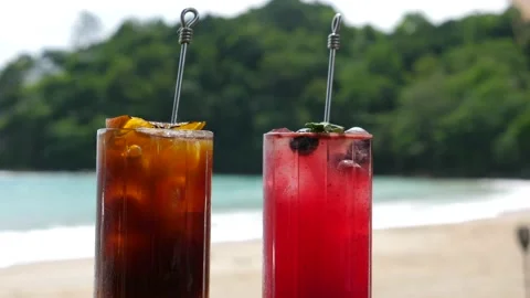 Beautiful Refreshing Fruit Cocktails on Table on Beach, Blue Sea on Background Stock Footage 159325504
