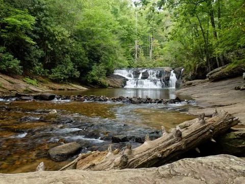 Beautiful remote mountain stream in summer with waterfall in the background Foto stock
