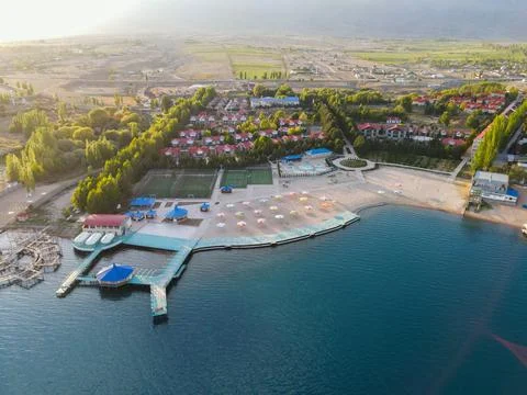 Beautiful resort complex on Issyk-Kul lake shore at sunset 스톡 사진