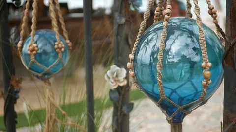 Beautiful retro decor and plants for garden. Set of blue sea buoys from glass Vidéo 123722366