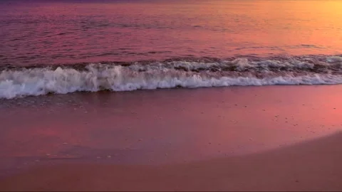 Beautiful rippled sea waves with reflection of pink and gold sunrise light. Stock Footage 243552922