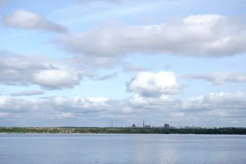 Beautiful ripples on river flow over colorful stones in summer sunshine Stock Photos