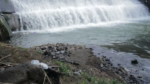 Beautiful River Flowing from a Three Level Dam with Trees Around It Stock Footage 267719969