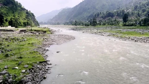 Beautiful River Flowing Through Mountainous Villages with Scenic Landscape 動画素材 339778361