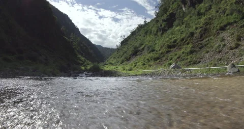A beautiful river flows through the heart of a mountainous gorge 스톡 동영상 292340727