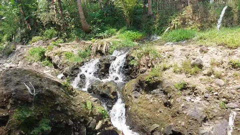 A beautiful river view with clear water and many large sediment rocks. Stock Footage 314223097