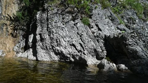 Beautiful rocks next to a mountain stream (slow motion) Video stock 219646620