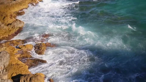 Beautiful rocky shore and sea waves crashing on the stones. Torredembarra, Spain Stock Footage