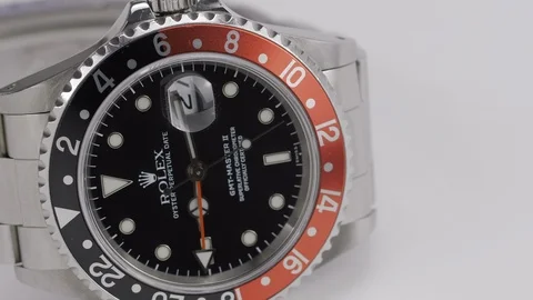 Beautiful Rolex GMT-Master II Cocke timepiece, rotating on a white Stock Footage 105110209