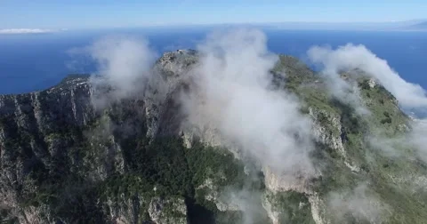 BEAUTIFUL ROLLING CLOUDS OVER STEEP ROCK CLIFFS IN CAPRI ITALY Stock Footage 63313611