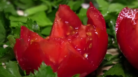 Beautiful rose-shaped tomatoes lie among greenery Stock Footage 341765155