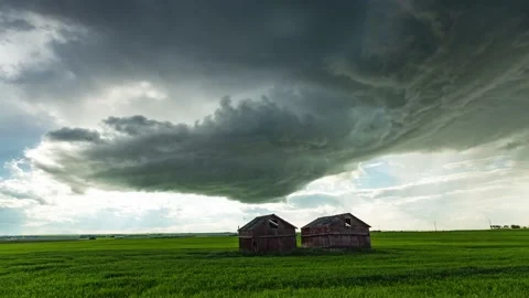 Beautiful rotating supercell over the Albertan Prairies with Barns Stock Footage 143325637