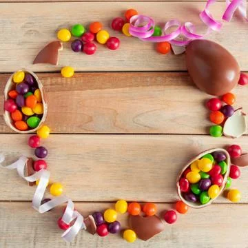 Beautiful round easter composition of chocolate eggs and sweets. Frame for de Stock Photos