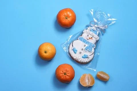 Beautiful round gingerbread cookie in the shape of a snowman on a blue backgr Stock Photos