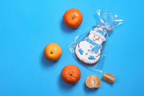 Beautiful round gingerbread cookie in the shape of a snowman on a blue backgr Stock Photos