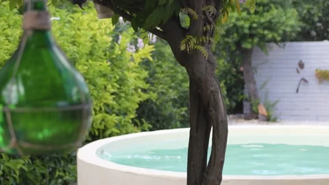Beautiful round pool surrounded by green countryside Stock Footage 141323950