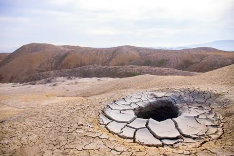 A beautiful, round, seething mud volcano in the mountains. Gobustan. Azerbaij Stock Photos