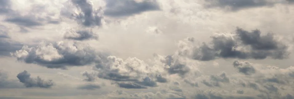 Beautiful row of clouds against the gray sky. Cloudy weather Stock Photos