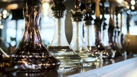 A beautiful row of flasks from hookahs steal the bar counter of the restaurant. Stock Footage 193518416