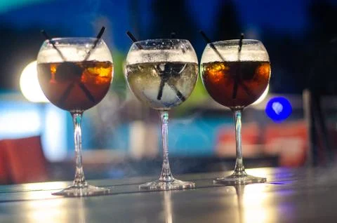 Beautiful row line of different colored alcohol cocktails on a party, martini Stock Photos