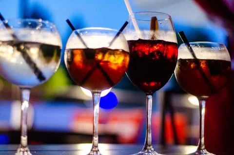 Beautiful row line of different colored alcohol cocktails on a party, martini Stock Photos