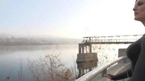 Beautiful runner stops and looks at the river Stock Footage 33665244