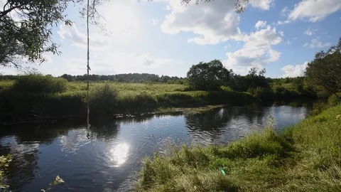 Beautiful russian small river and bungee jump rope on a tree Stock Footage 104956739