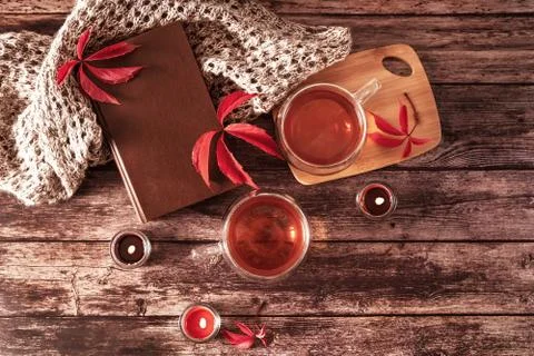 Beautiful rustic template of two cups of tea and book on wooden background. Cozy Stock Photos